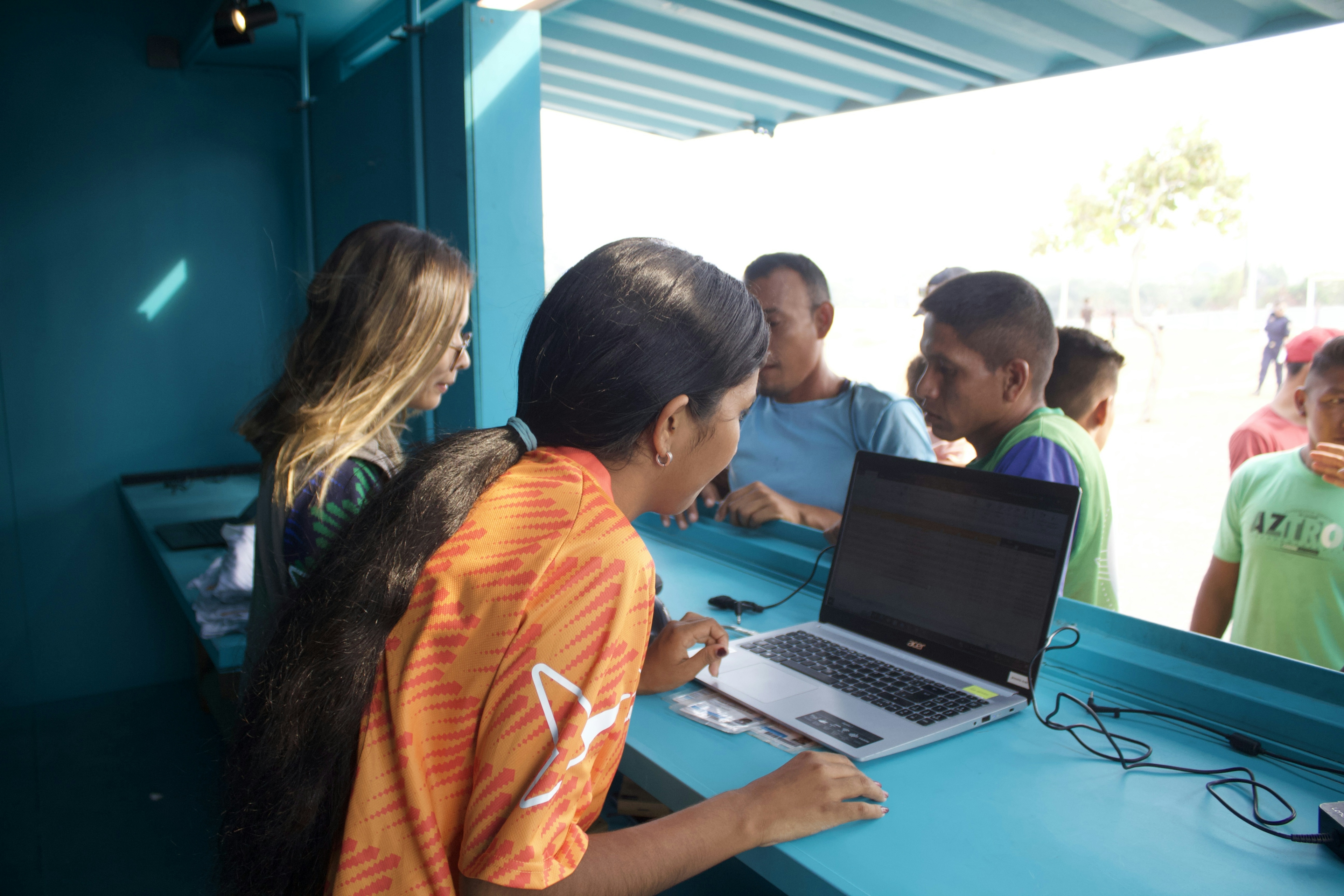 Divennys managing borrowings at Boa Vista clubhouse on laptop