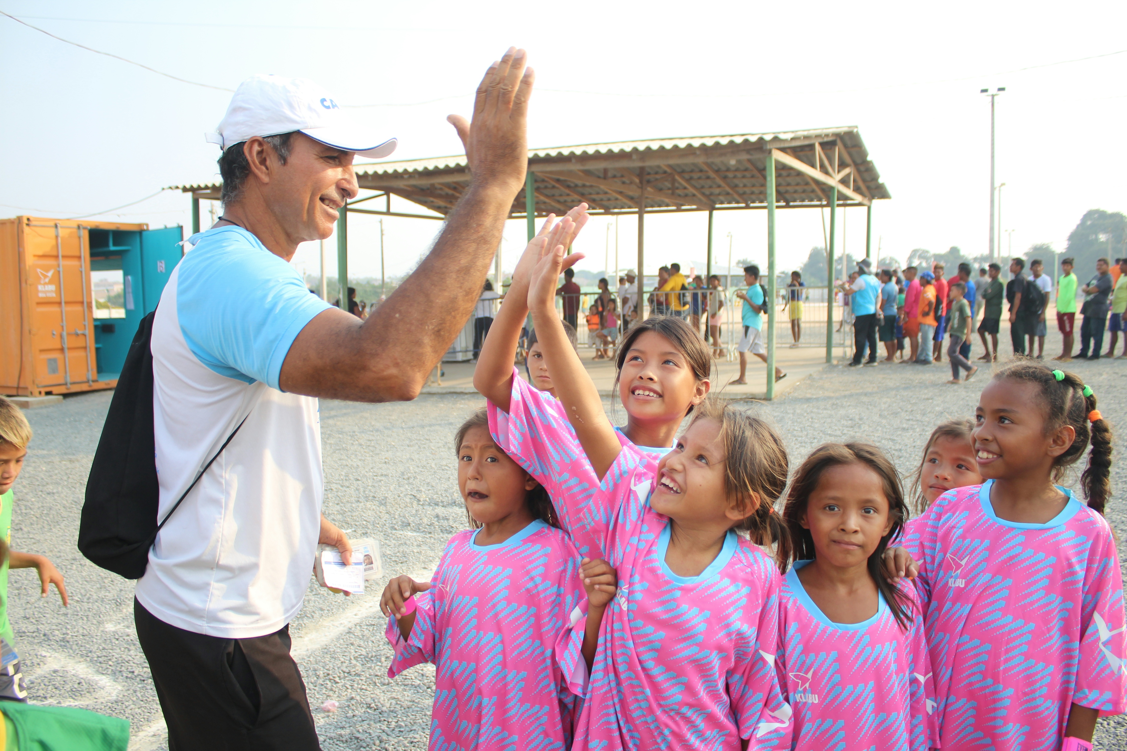 Trainer Gustavo high fiving his girls running team